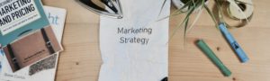 A sheet on a table that reads marketing strategy